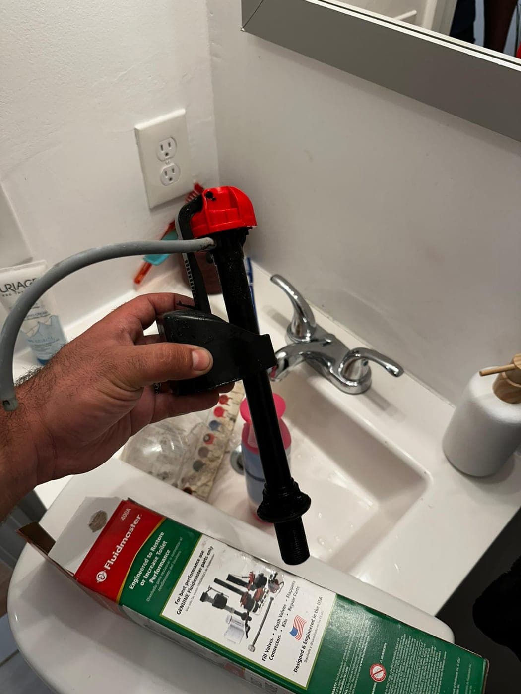 Plumber's tools laid out for a faucet cartridge repair in a North Jersey kitchen