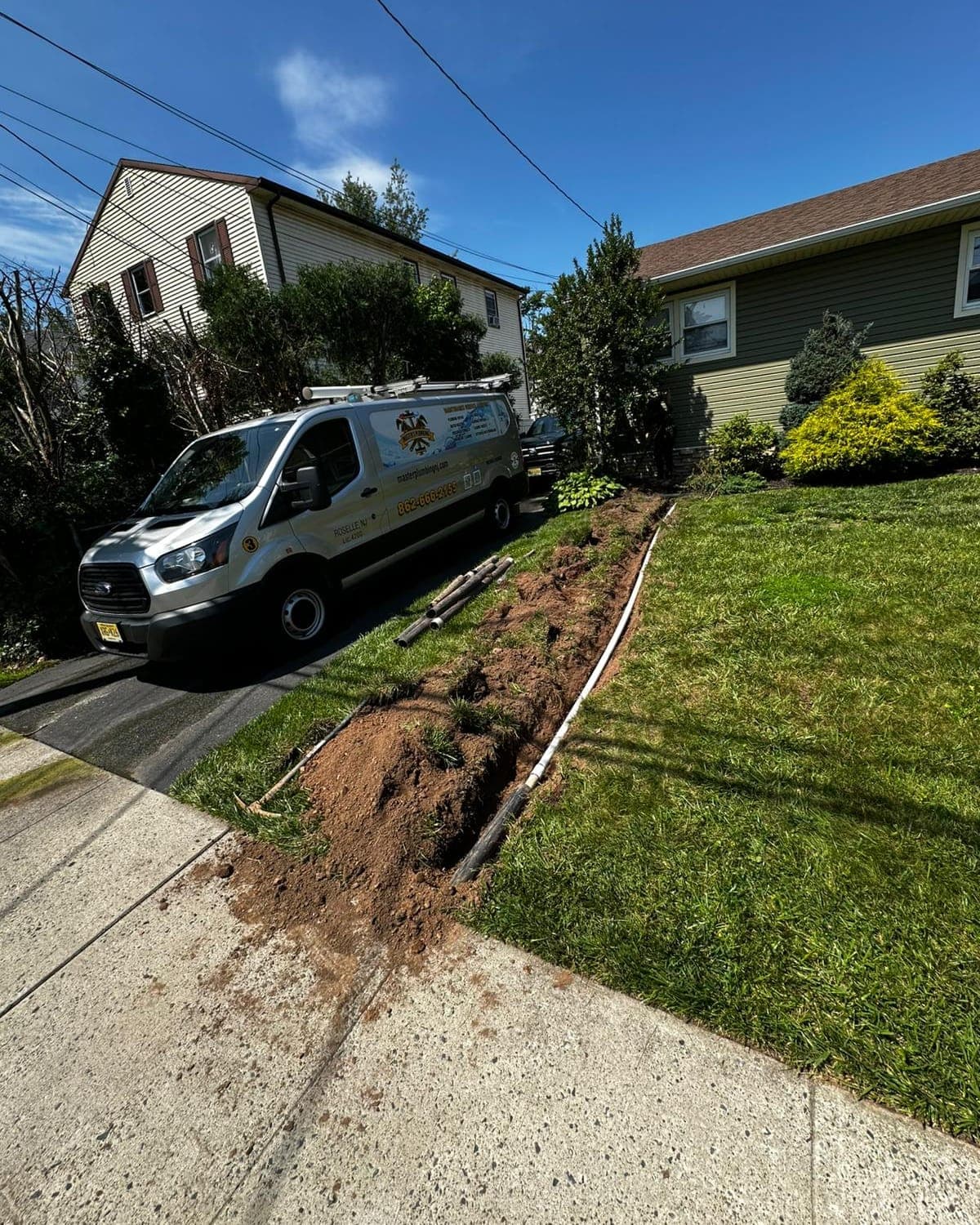 Master's Plumbing van parked at a home during a sewer line replacement