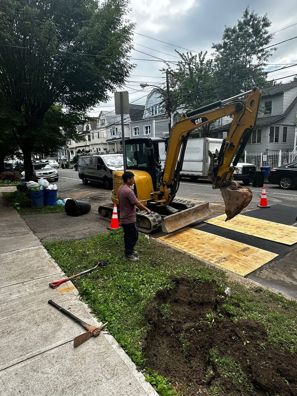 Excavator opening the street for a sewer connection