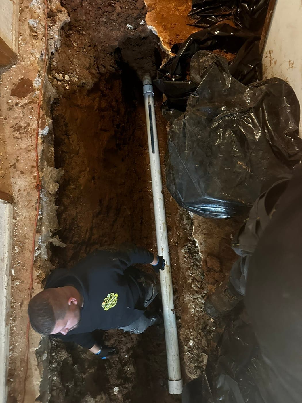 Technician installing an underground drain line