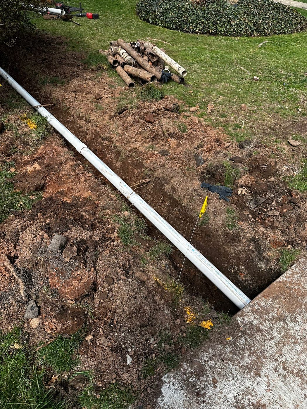 New water line in a trench across a front lawn